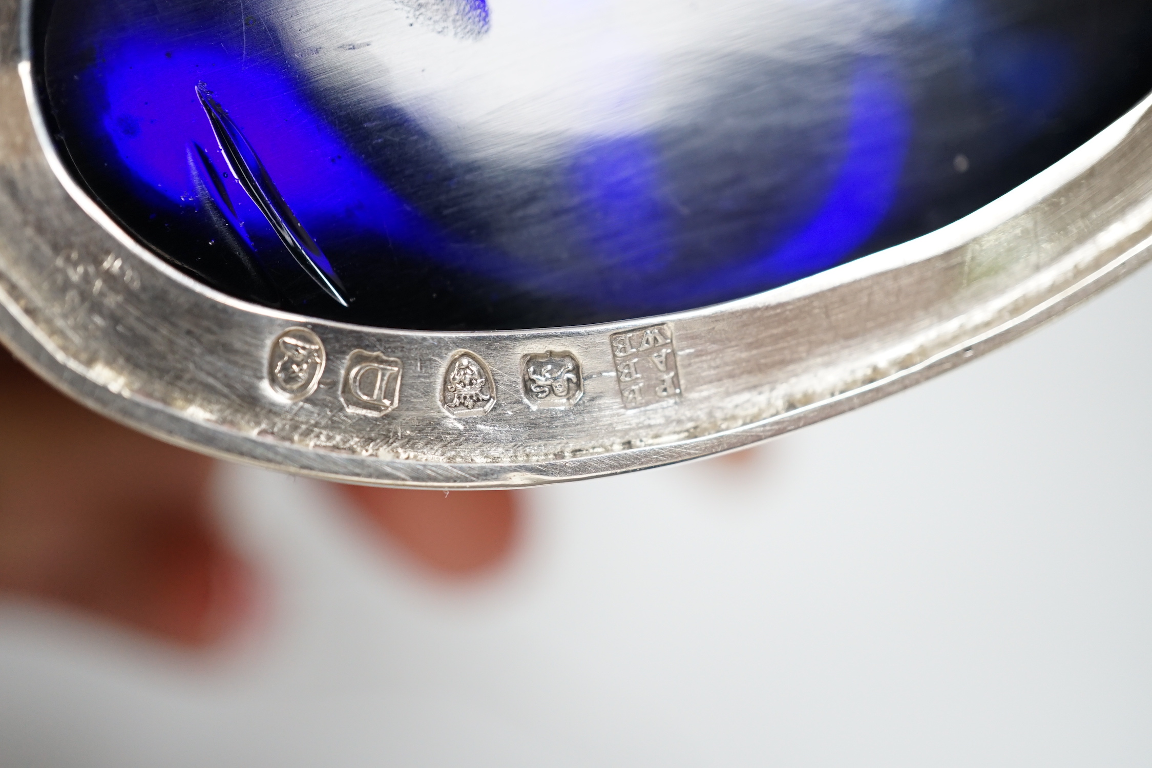 A George III oval silver drum mustard, with domed lid, blue glass liner and associated plated spoon, makers Peter, Anne and William Bateman, London 1799, 110 grams